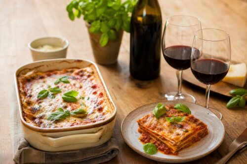 Lasagnes maison gratinées avec un verre de vin rouge